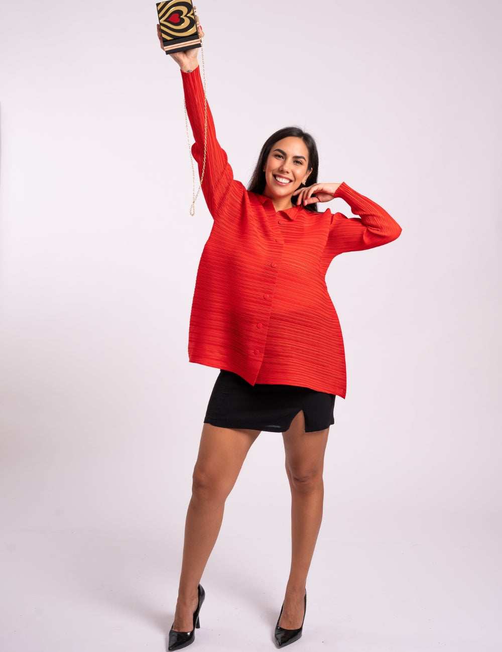 Mujer sonríe usando la blusa Aurora en color rojo. 