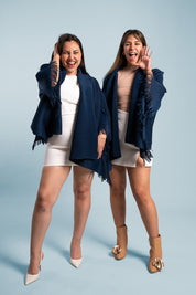 Dos mujeres usando la capa Visionaria en color azul. 